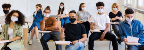 一群戴着口罩的学生在教室里